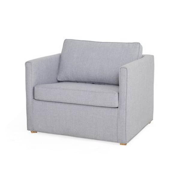 The Månö is a modern armchair upholstered in light gray, with square arms, a straight back, wooden feet, and features cushioned seat and backrest.